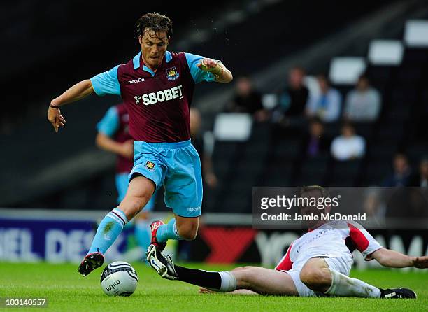 Scott Parker of West Ham United battles with Dietmar Hamann of MK Dons during the pre-season friendly match between MK Dons and West Ham United at...