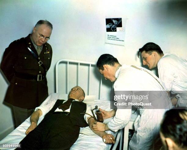 Surgeon General of the United States Army Major General James C. McGee speaks with US Under Secretary of War Robert P. Patterson as the latter's...