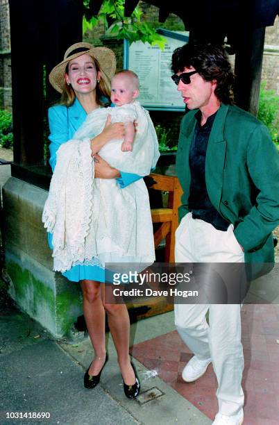Jerry Hall and singer of The Rolling Stones, Mick Jagger with their daughter Georgia May Jagger during her christening at Saint Andrew's church,...