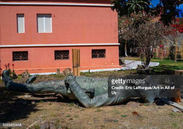 Old bronze portuguese statue laying down on the grass, Huila Province, Lubango, Angola on July 20, 2018 in Lubango, Angola.