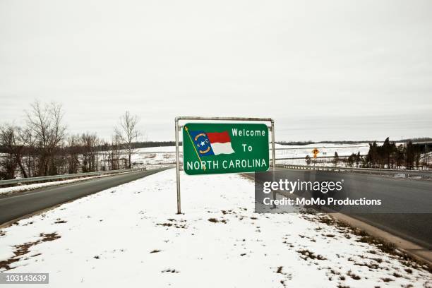 welcome to north carolina sign in winter. - north carolina stock pictures, royalty-free photos & images