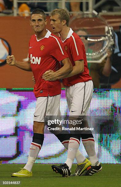 Federico Macheda of Manchester United celebrates with a teammate after scoring a goal against the MLS All Stars in the first minute of the MLS All...