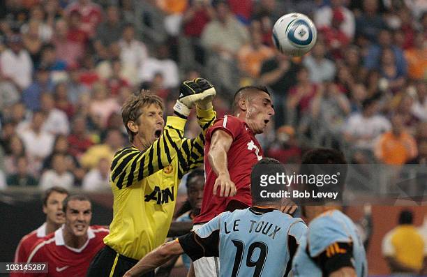 Edwin van der Sar and Federico Macheda of Manchester United jump to defend the ball during the MLS All Star Game at Reliant Stadium on July 28, 2010...