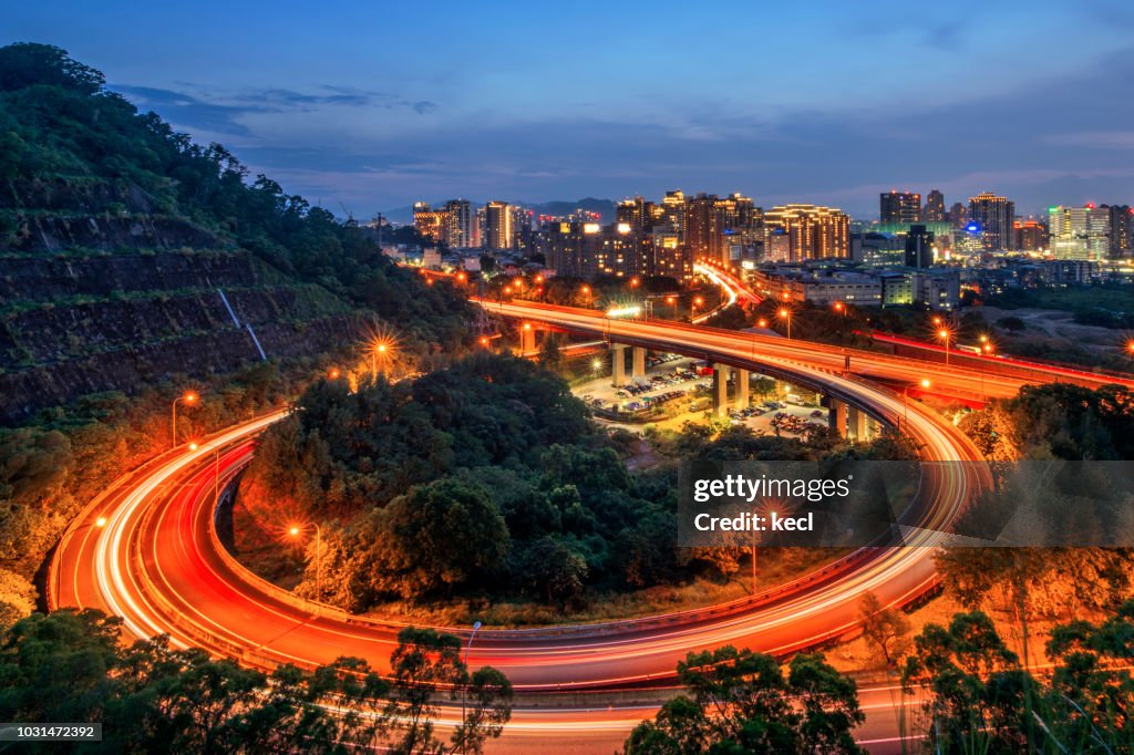 Car light trails of highway interchange