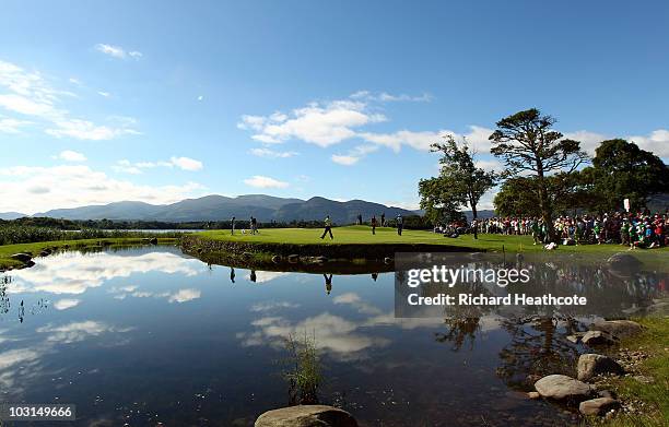 Rory McIlroy and Darren Clarke of Northern Ireland and Rhys Davies of Wales walk onto the 10th green during the first round of the 3 Irish Open at...