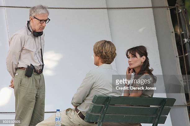 Director Woddy Allen speaks with actors Carla Bruni Sarkozy and Owen Wilson during the filming of 'Midnight in Paris' directed by Woody Allen on July...