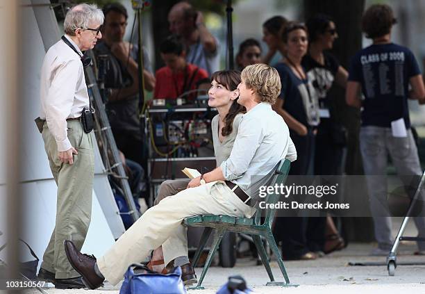 Director Woddy Allen speaks with actors Carla Bruni Sarkozy and Owen Wilson during the filming of 'Midnight in Paris' directed by Woody Allen on July...