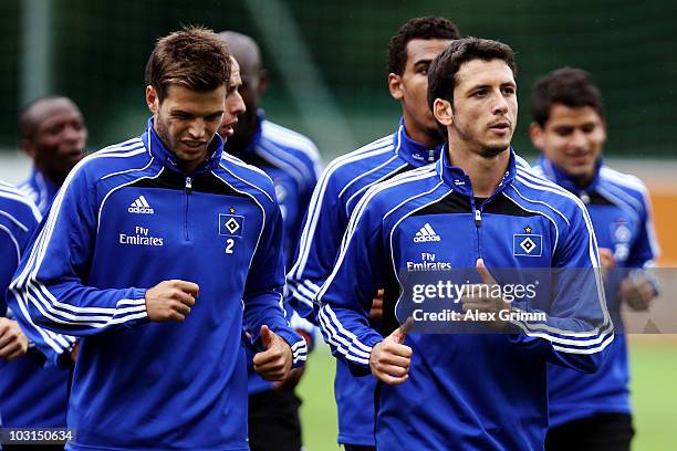 Dennis Diekmeier and Gojko Kacar run with team mates during the pre-season training camp of Hamburger SV at the Aqua Dome hotel on July 29, 2010 in...