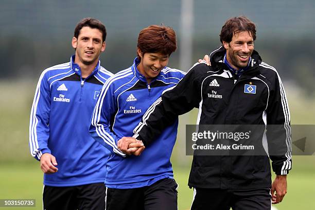 Gojko Kacar walks past Heung-Min Son and Ruud van Nistelrooy during the pre-season training camp of Hamburger SV at the Aqua Dome hotel on July 29,...