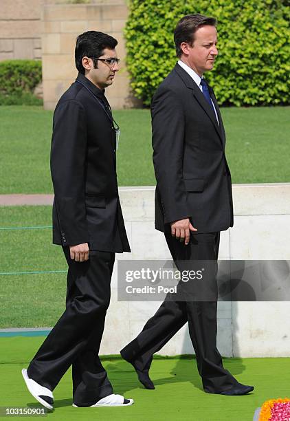 British Prime Minister David Cameron removes his shoes as he visits the Gandhi Memorial at Rajghat on July 29, 2010 in Delhi, India. The British...