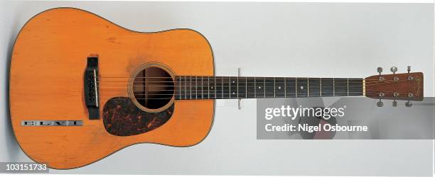 Studio still life of a 1942 Martin D-18 acoustic guitar owned by Elvis Presley, photographed in the United Kingdom.