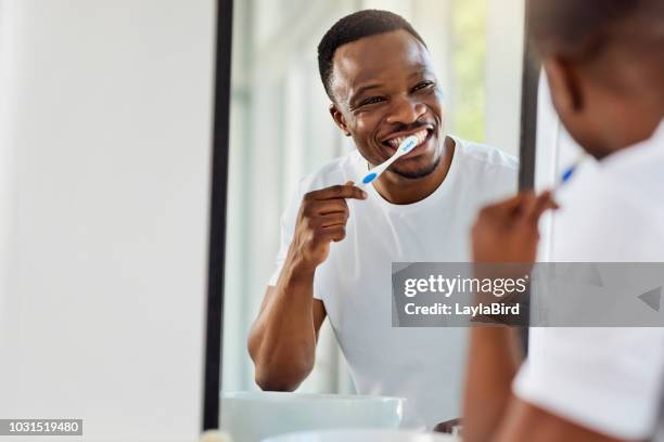 looking after my teeth is part of my look - adult in mirror stock pictures, royalty-free photos & images