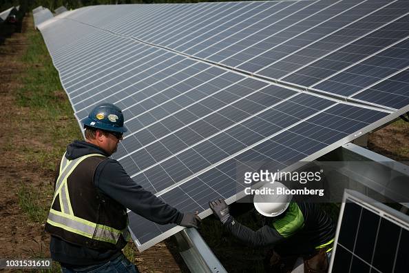 workers-install-solar-panels-at-the-connexus-energy-athens-township