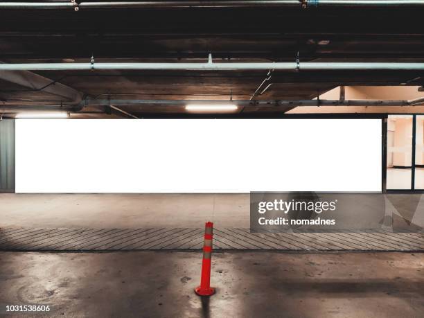 blank billboard banner at underground parking lot.mystical moody advertising template. - horizontaal stockfoto's en -beelden