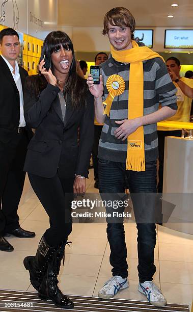 American R&B artist, Kelly Rowland poses for a photo with the first customer Jack Breen at the release of the iPhone 4 for Optus on July 30, 2010 in...
