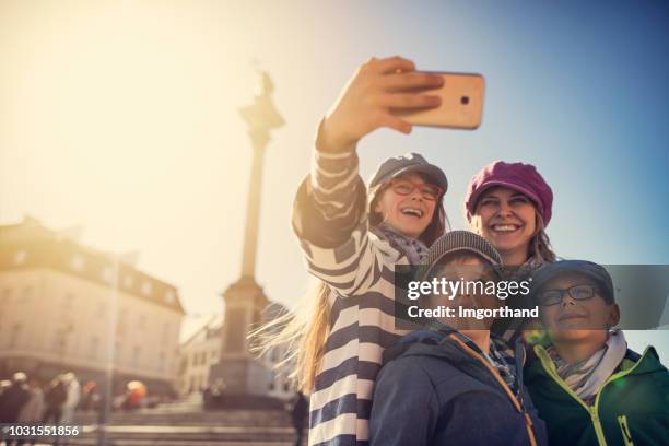 tourists family making selfie at warsaw, poland - daily life in warsaw stock pictures, royalty-free photos & images