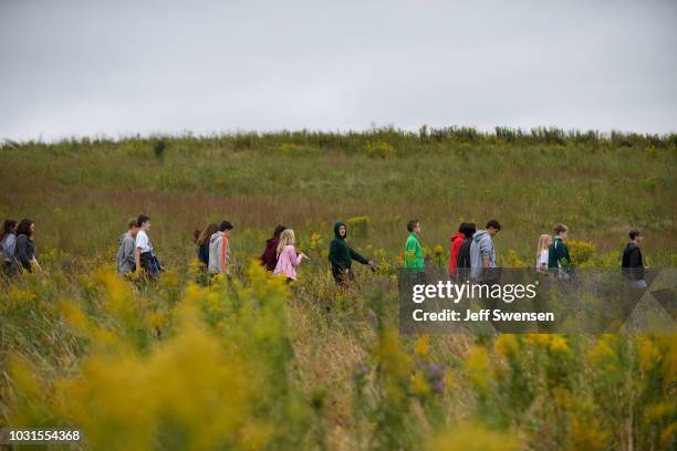 Visitors stroll through the fields along the path to the Wall of Names after listening to President Donald Trump deliver a speech at the Flight 93...