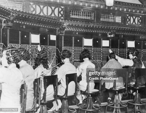View of telephone operators at a switchboard exchange in Chinatown, San Francisco, California, 1925.