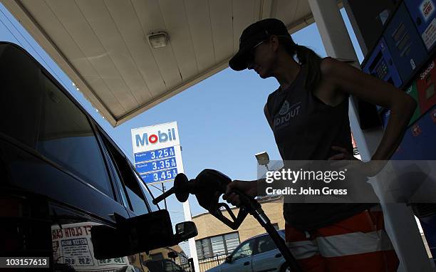 Anastasia Hinchsliff fuels her SUV at an Exxon Mobile gas station July 29, 2010 in Chicago, Illinois. Exxon Mobile's quarterly profits were released...