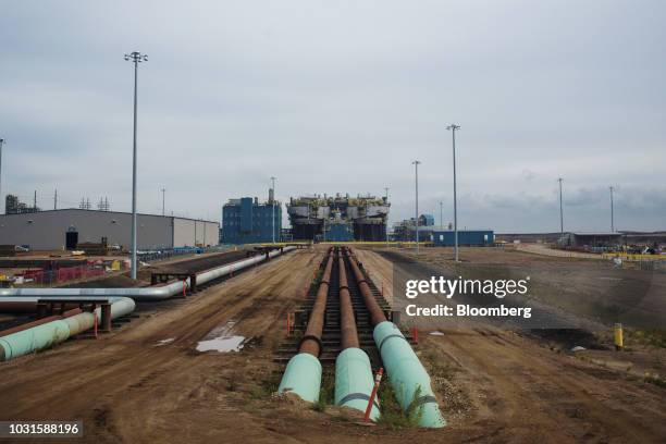 Pipes carrying bitumen to a secondary extraction unit are seen during a grand opening event for the Suncor Fort Hills oil-sands extraction site near...