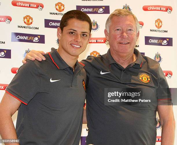 Javier "Chicharito" Hernandez and Sir Alex Ferguson of Manchester United pose ahead of a press conference ahead of their pre-season friendly match...