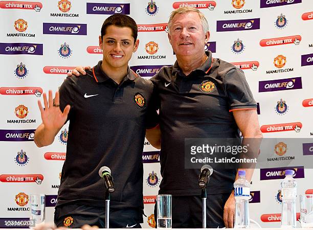 Player Javier Hernandez and head coach Alex Ferguson of Manchester United pose for photographers during a press conference one day before a friendly...