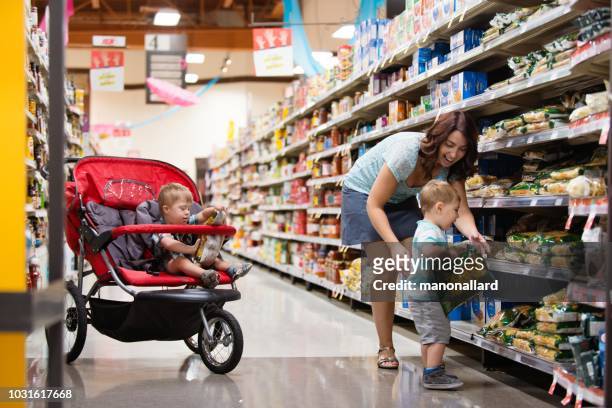 Mom at the grocery store with his son with Down Syndrome