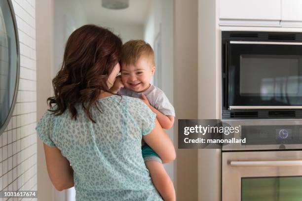 three years old little boy with down syndrome with his mom - developmental disability stock pictures, royalty-free photos & images