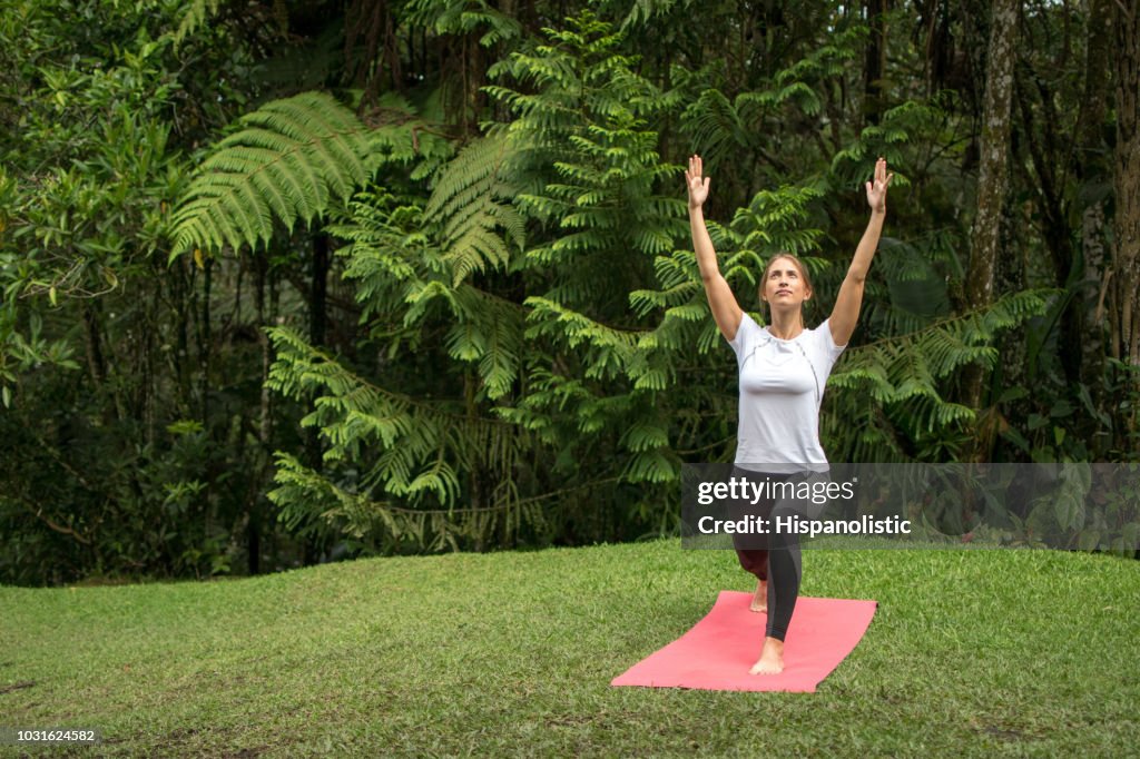 Woman outdoors doing yoga and relaxing