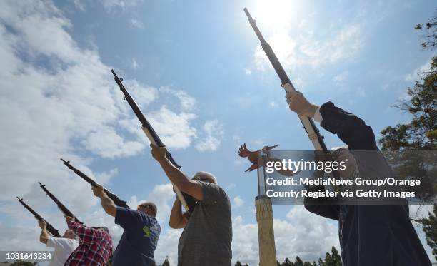 Dennis Bronson, left, joins other members of the Huntington Beach American Legion Post 133 Honor Guard as they practice their firing squad routine on...