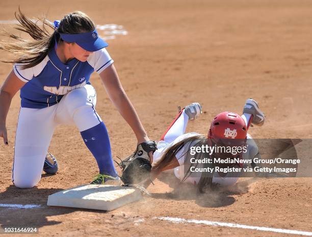 Mater Dei's Brittany McConnell slides back in to first as Santa Margarita Catholic's Jenna Cone fails to tag her during their Trinity League game in...
