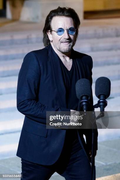 Irish lead singer of rock band U2, Paul David Hewson aka Bono delivers a statement in the courtyard of the Elysee Palace, in Paris, after a meeting...