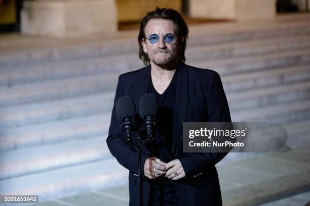 Irish lead singer of rock band U2, Paul David Hewson aka Bono delivers a statement in the courtyard of the Elysee Palace, in Paris, after a meeting...