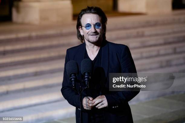 Irish lead singer of rock band U2, Paul David Hewson aka Bono delivers a statement in the courtyard of the Elysee Palace, in Paris, after a meeting...