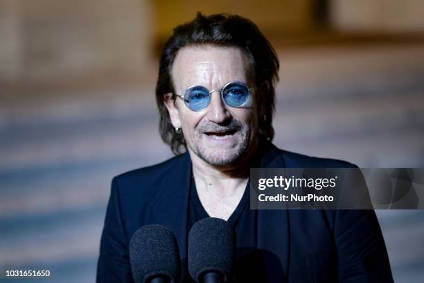 Irish lead singer of rock band U2, Paul David Hewson aka Bono delivers a statement in the courtyard of the Elysee Palace, in Paris, after a meeting...