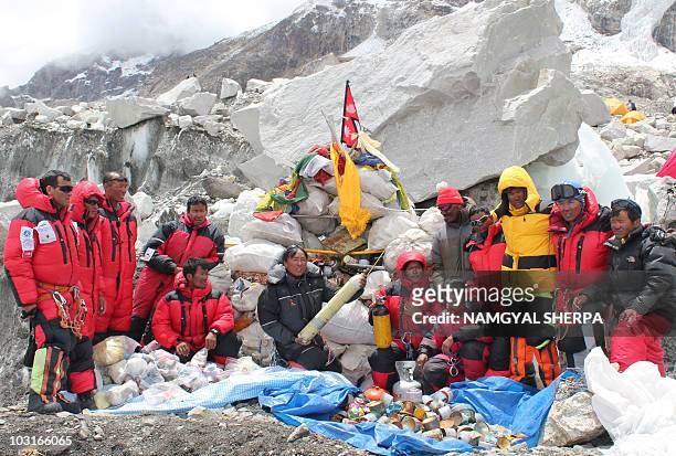 This picture taken on May 28, 2010 shows Nepalese sherpa climbers posing after collecting garbage from the Everest clean-up expedition at Everest...