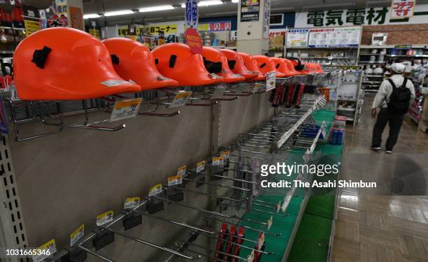 An empty shelf is seen as flashlights and power generators are almost sold out at a shop on September 11, 2018 in Sapporo, Hokkaido, Japan. A male...