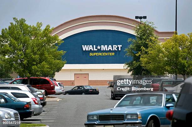 Customers drive through the parking lot of a Wal-Mart Supercenter store located about a mile from a new Family Dollar store that opened on May 6 in...