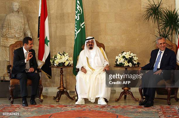 Syrian President Bashar al-Assad gestures as he sits along side Saudi Arabia's King Abdullah and Lebanese President Michel Sleiman prior to their...