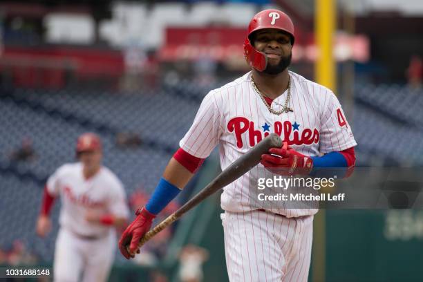 Carlos Santana of the Philadelphia Phillies reacts after striking out to end the bottom of the first inning against the Washington Nationals in game...