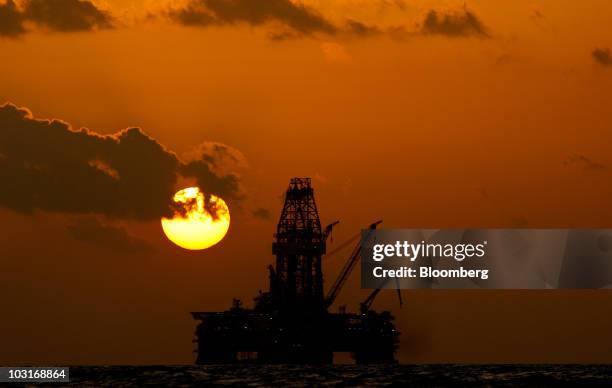 The Transocean Development Driller III leased by BP Plc is seen at sunset as it works to drill a backup relief well at the BP Plc Macondo well site...