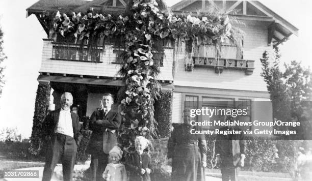 Original caption: These folks are standing in front of the Denni Mansion, which was built by G. W. Hughes, the original developer of the hilltop area...