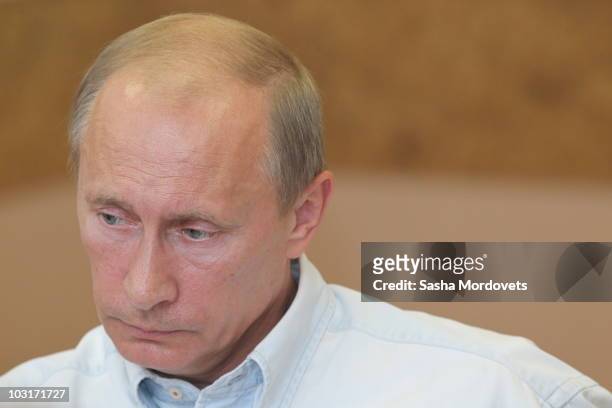 Russian Prime Minister Vladimir Putin meets with Emercom officials on July 30, 2010 in Vyksa, Russia. According to the Russian Emergency Situations...