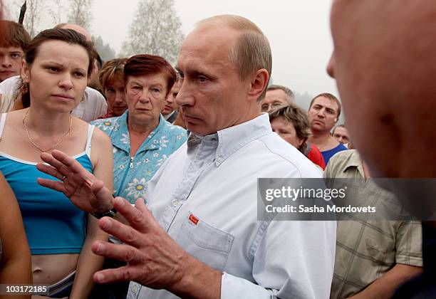 Russian Prime Minister Vladimir Putin meets with people, who suffered from forest fires which swept through their village on July 30, 2010 in...