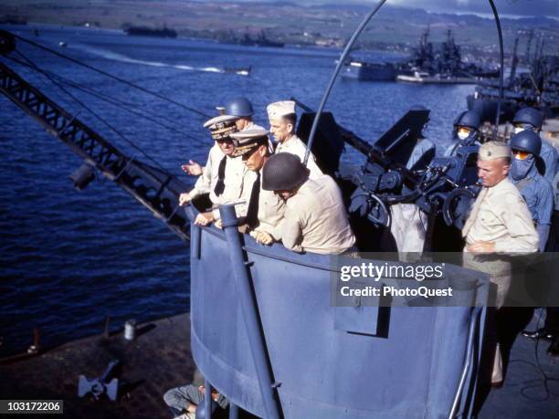 Admiral Chester William Nimitz, , Vice Admiral Raymond A. Spruance , and Major Gen Holland M. Smith look over the edge of a 20mm gun tub, Pearl...