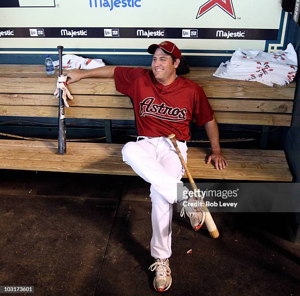 First baseman Lance Berkman of the Houston Astros sits in the dugout during batting practice before the Milwaukee Brewers play the Houston Astros at...