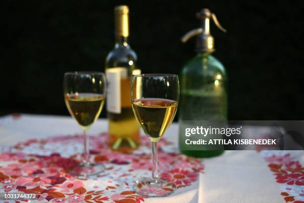 Picture taken on September 7, 2018 in Budapest shows glasses of "froccs" spritzer, a centuries-old Hungarian drink made out of wine and soda. - The...