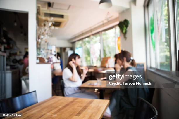 female customers spending relaxing in the afternoon cafe - cafe culture stock pictures, royalty-free photos & images