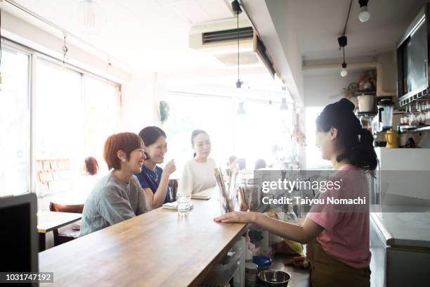 women spending their time in the afternoon cafe - women meeting lunch stock pictures, royalty-free photos & images