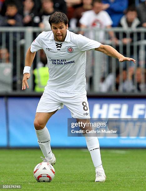 Florian Bruns of St. Pauli runs with the ball during the pre-season friendly match between FC St. Pauli and Racing Santander at Millerntor Stadium on...